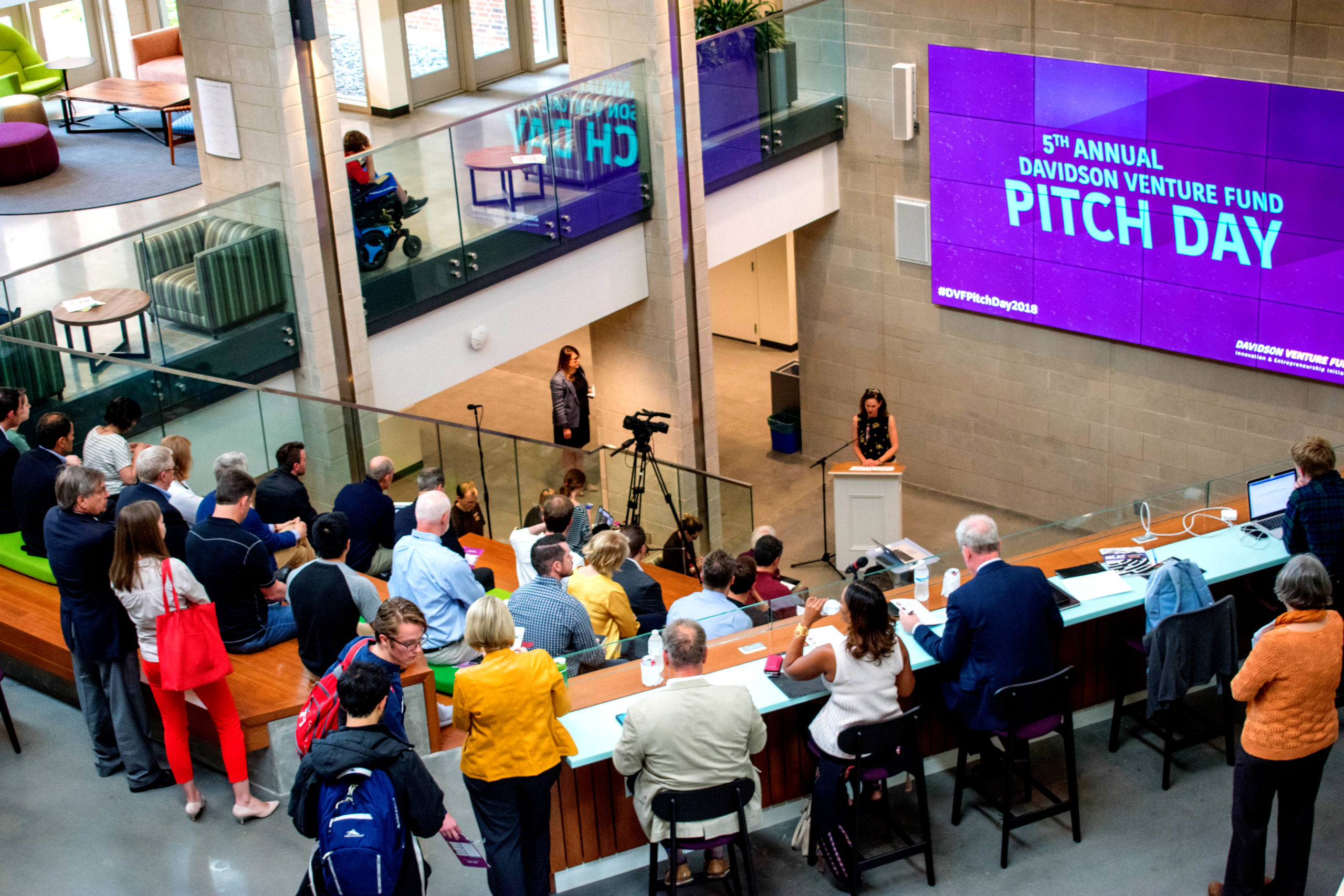 Carol Quillen speaks at the 5th annual Davidson Venture Fund Pitch Day in front of an audience in the Wall gallery