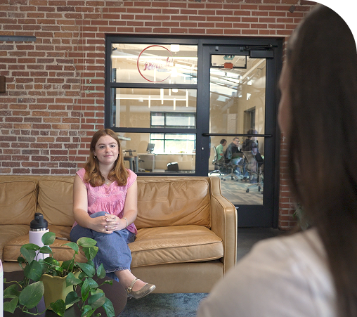 A student sitting on a sofa in Social Commons