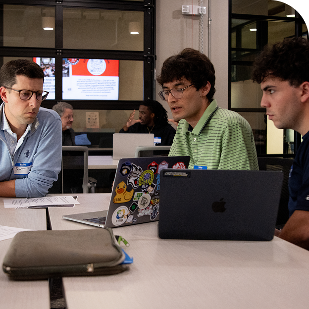 Mentors and students working together at a pitch event