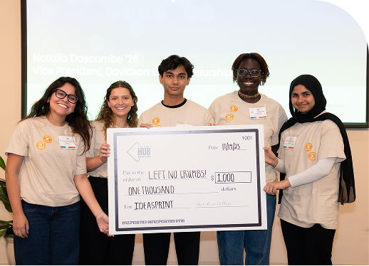 The winning IdeaSprint team holding an oversized $1,000 cheque made out to Left No Crumbs
