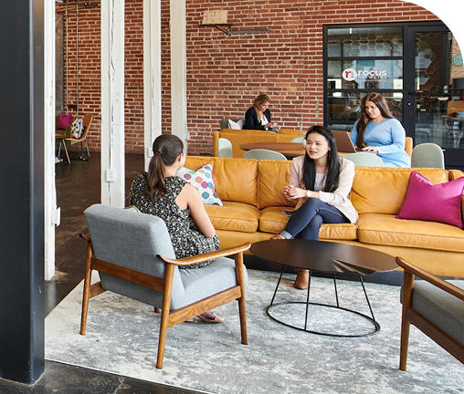 Coworkers talking on the lounge sofas