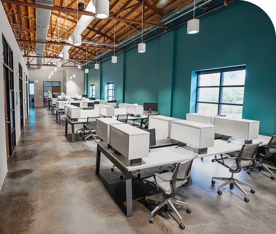 Row of dedicated desks against a teal wall