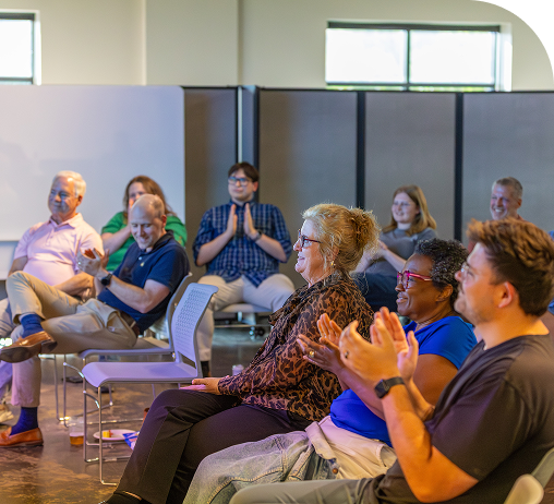 Audience applauding at a Hurt Hub workshop
