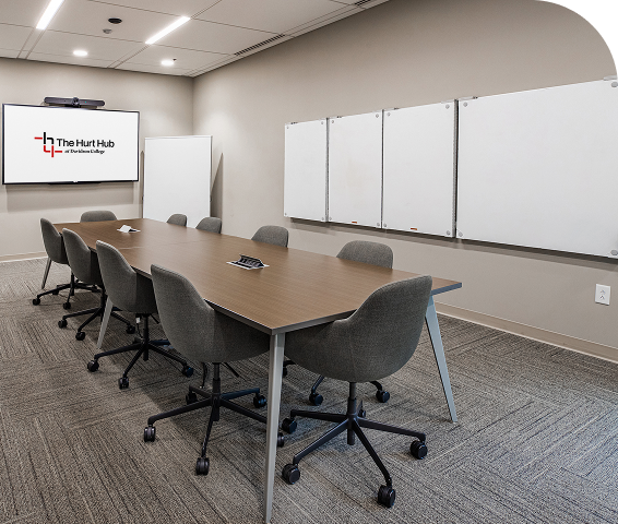 Meeting room with a long table and whiteboards